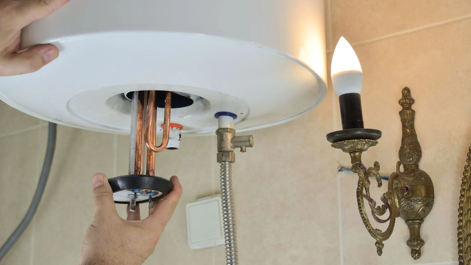 JK Plumbing plumber carrying a replacement water heater into a South San Francisco garage