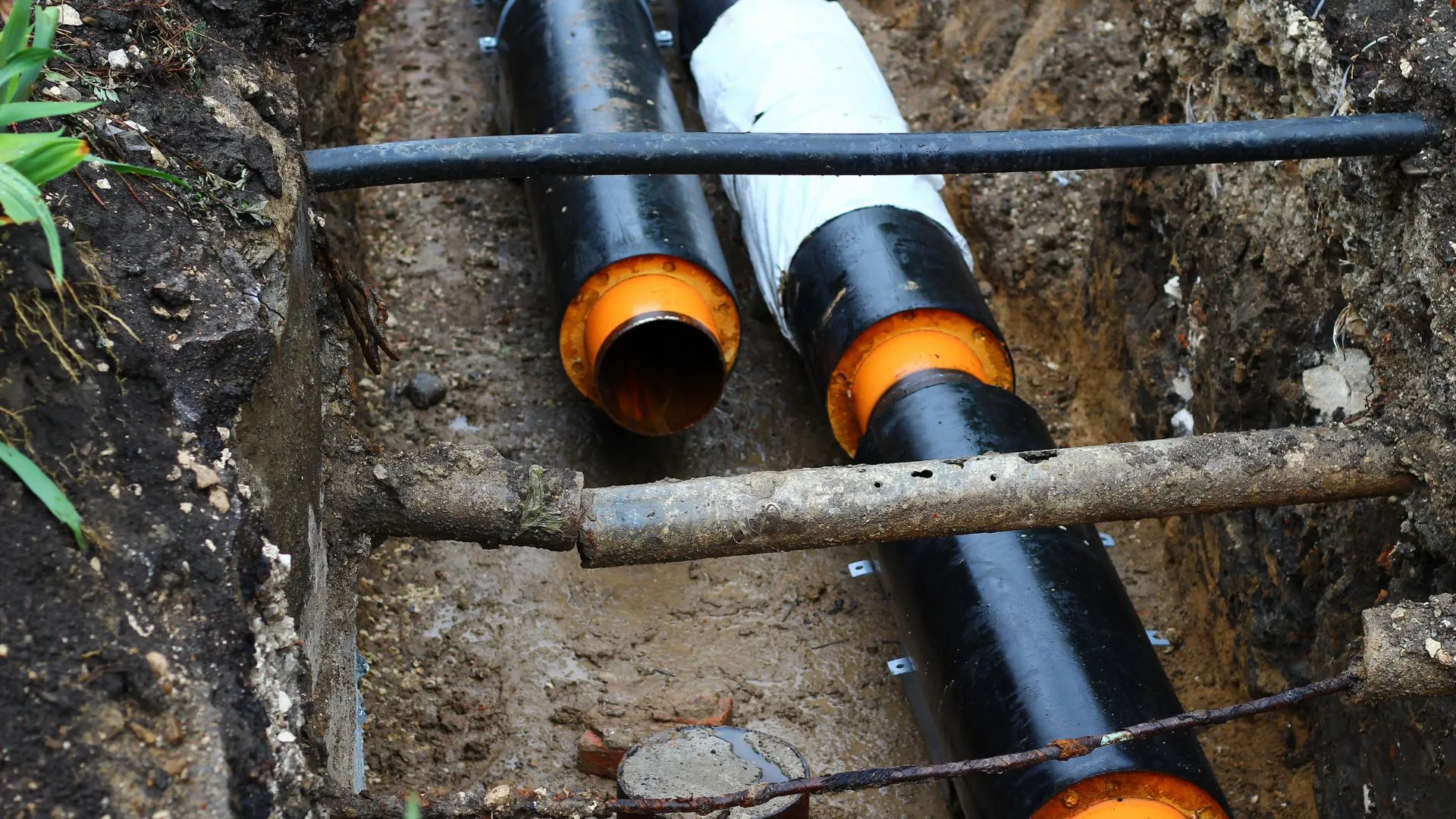 JK Plumbing crew working an open sewer lateral excavation at a San Francisco property