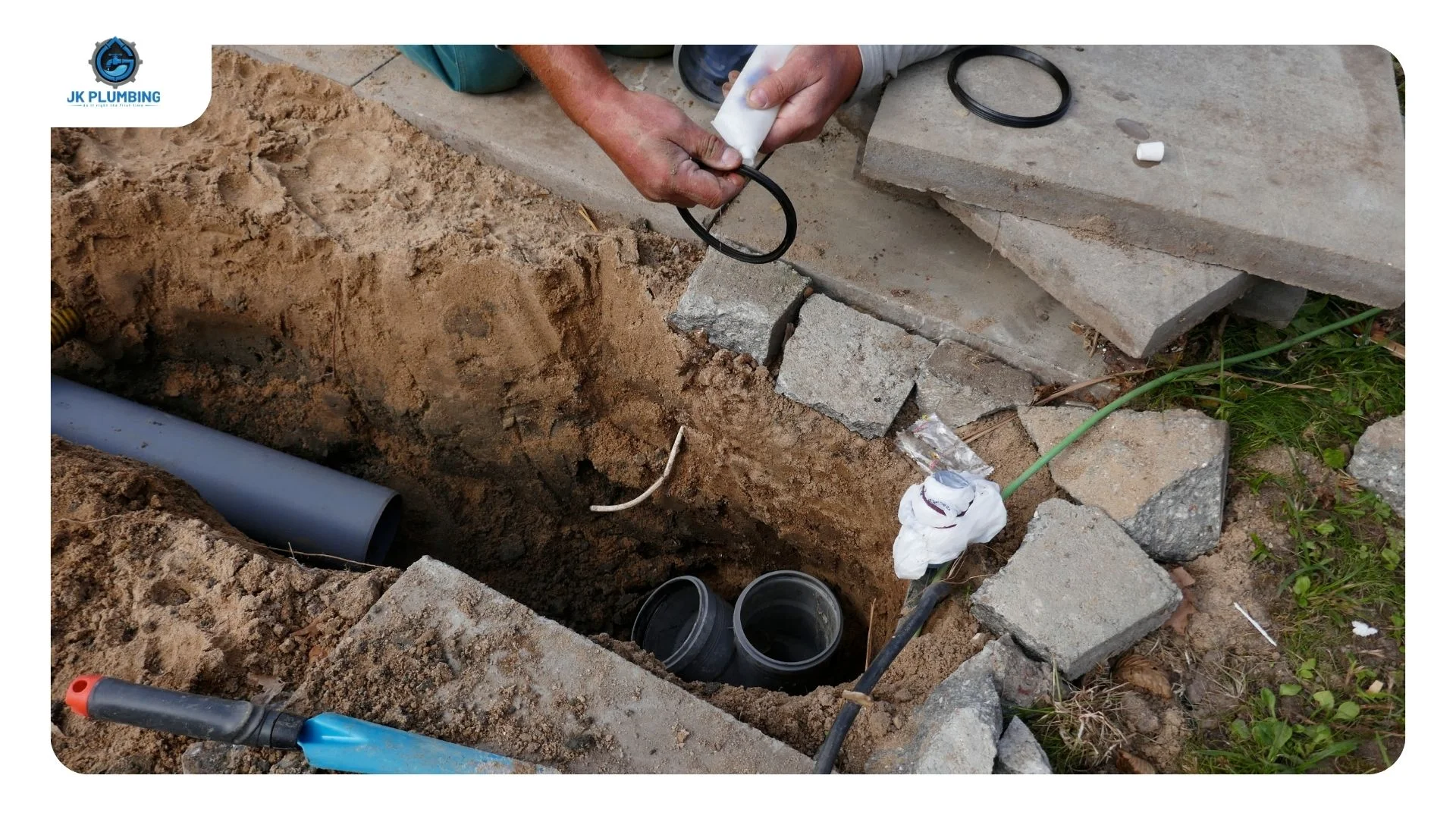 Two small trenchless access pits at either end of a sewer lateral run with the lawn between them undisturbed