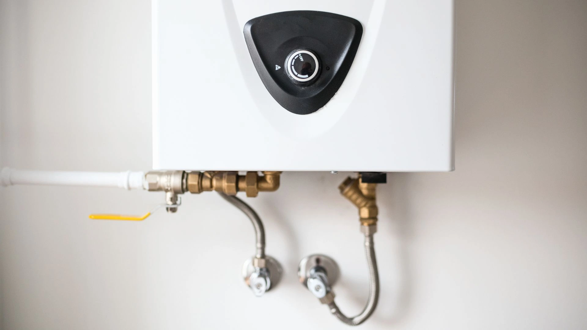 JK Plumbing technician installing a water heater in an older San Francisco home
