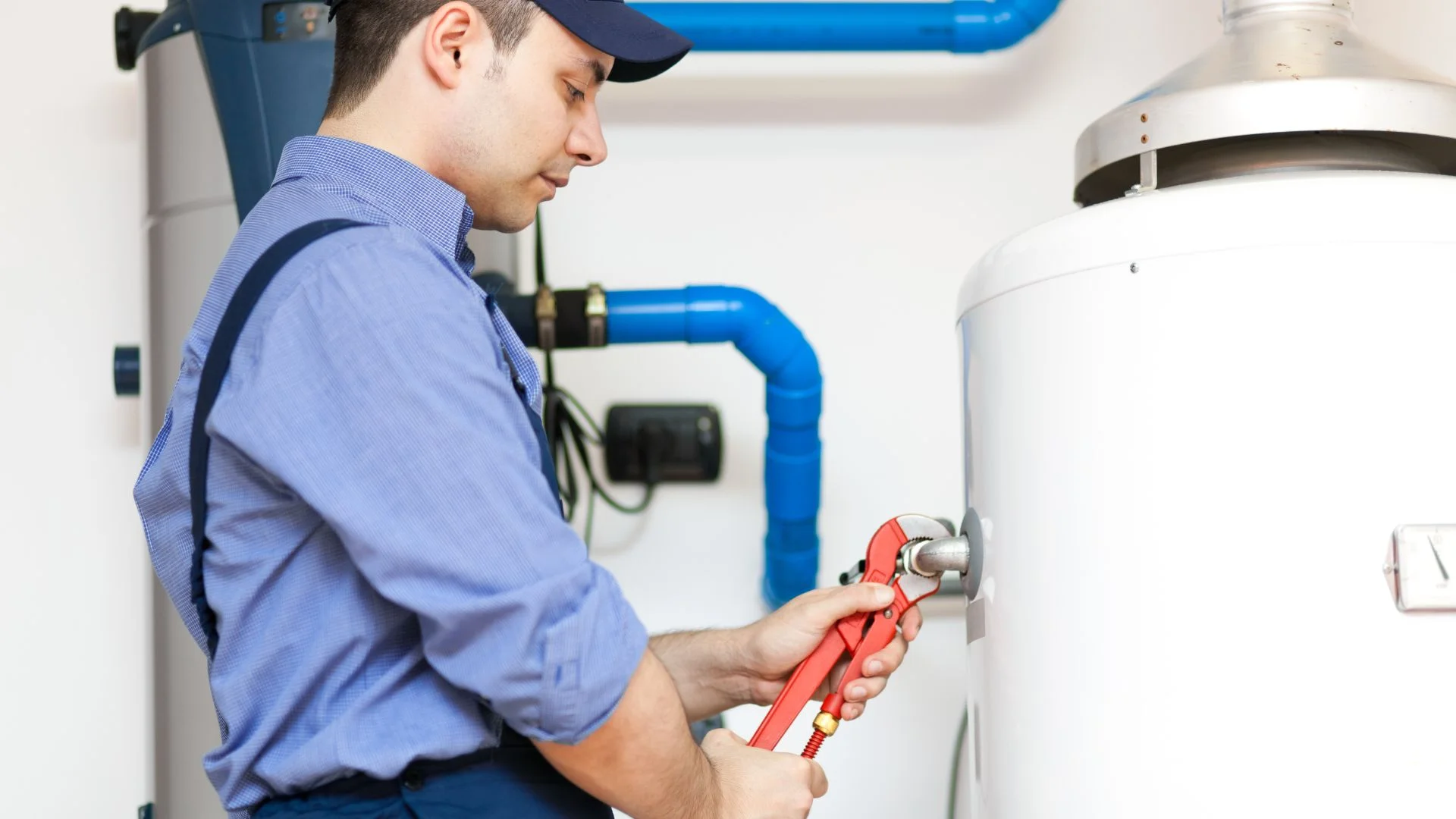 JK Plumbing technician diagnosing a gas water heater fault in a San Francisco garage