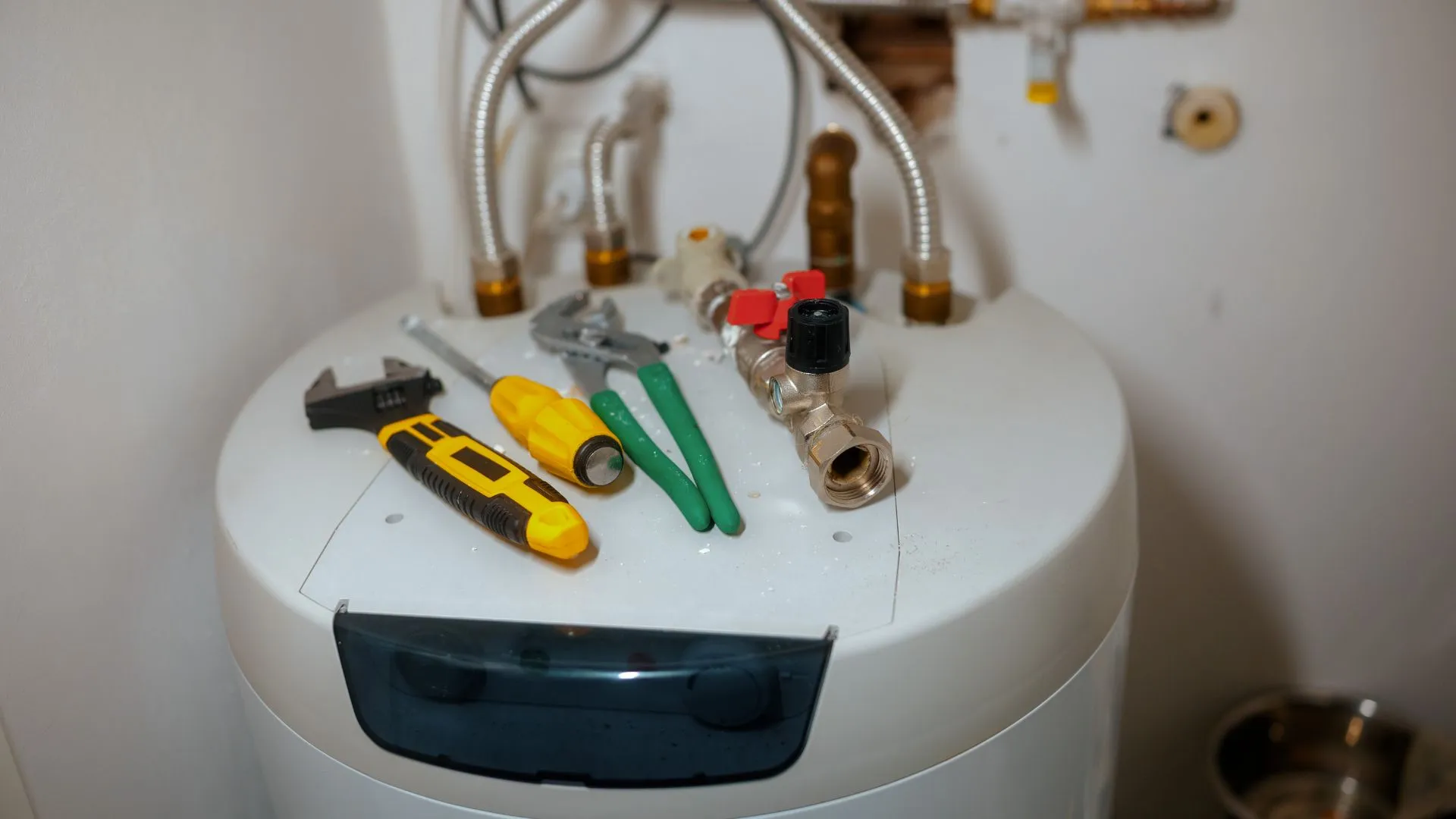 JK Plumbing technician diagnosing a gas water heater in a Palo Alto home