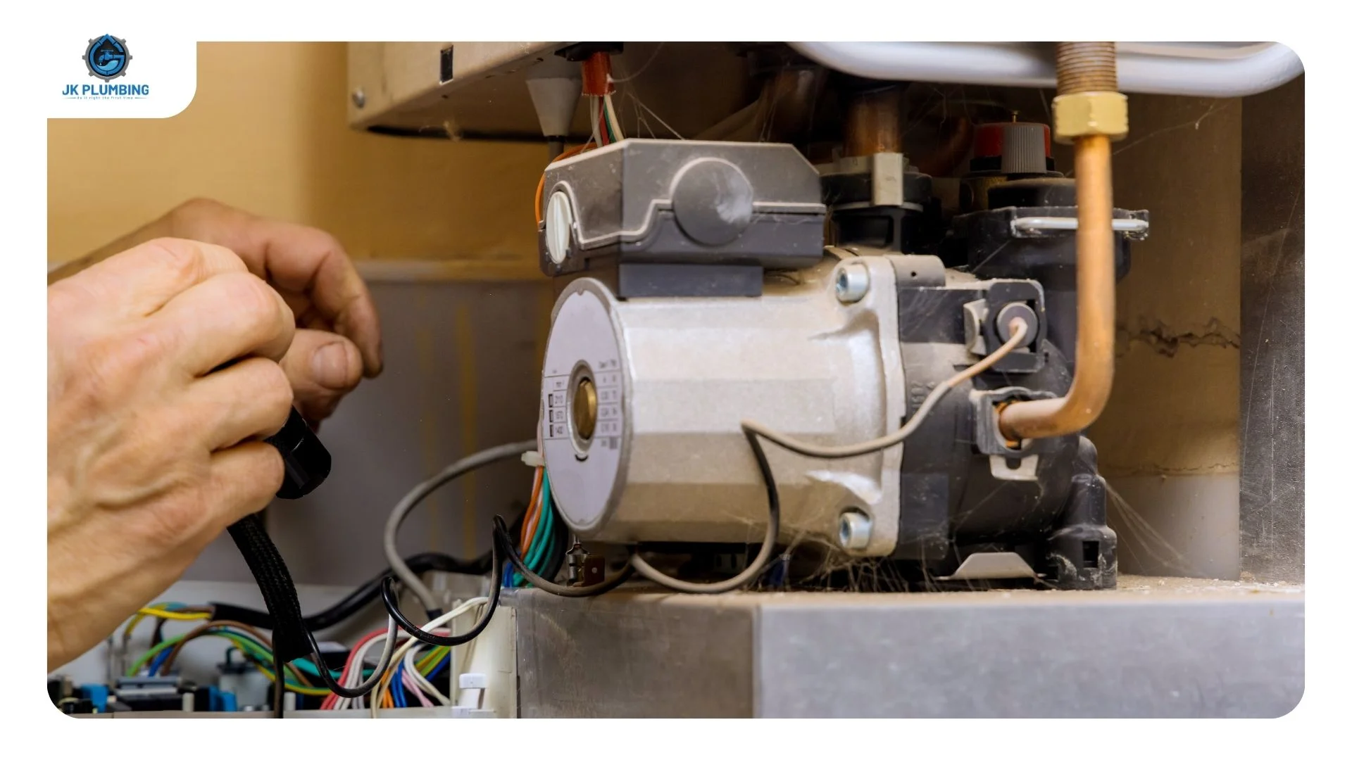 Plumber inspecting the pilot assembly and thermocouple on a gas water heater that has lost hot water