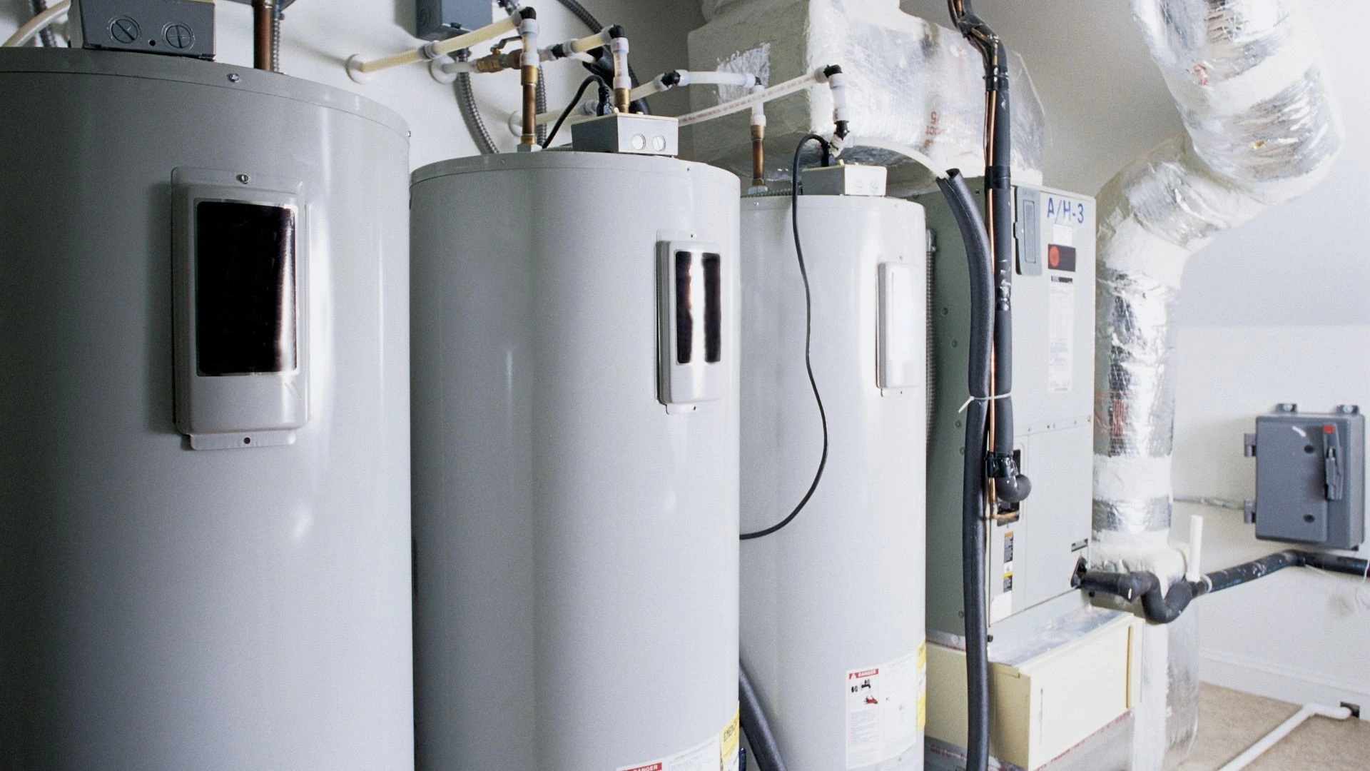 JK Plumbing technician replacing a failed water heater in a San Francisco garage