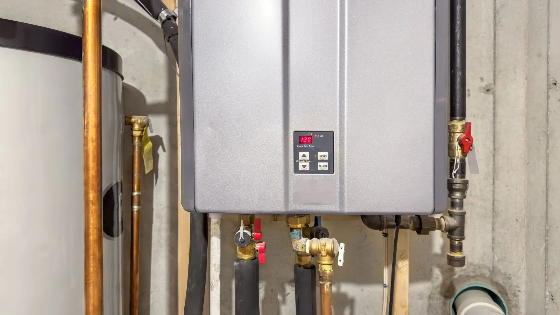 New 50 gallon water heater installed with seismic straps, expansion tank and drain pan in a San Mateo garage