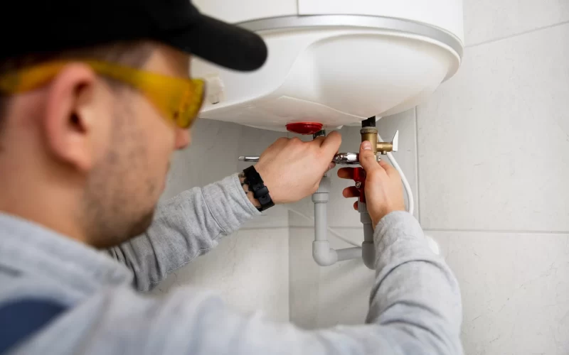 worker-repairing-water-heater